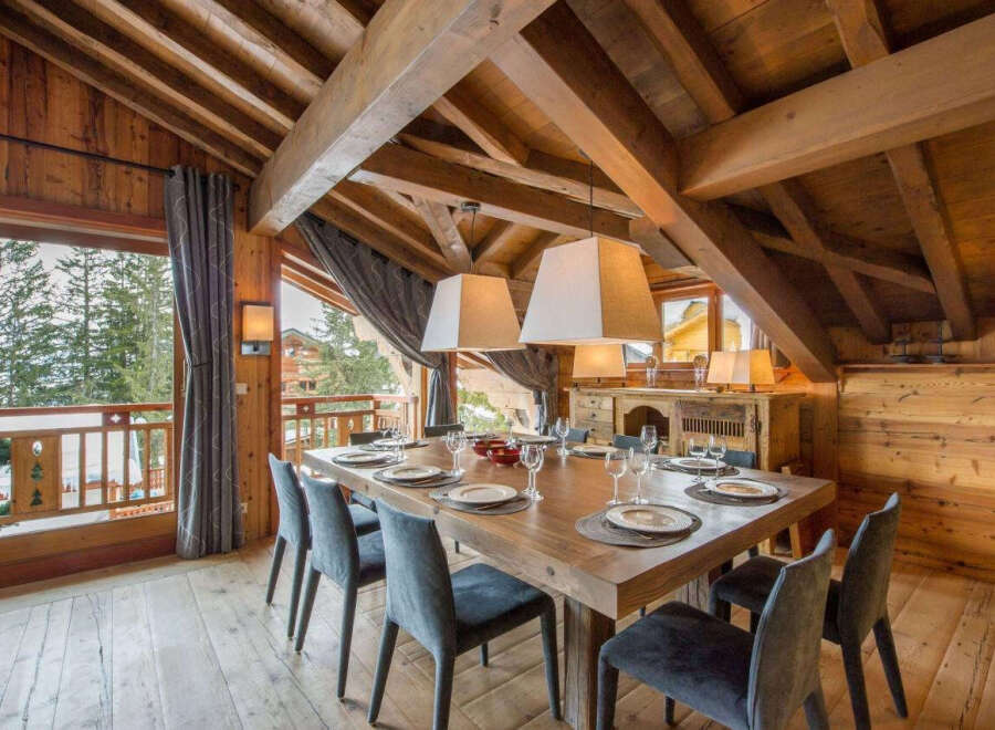 Experience luxury living in this stunning chalet, featuring a spacious dining area perfect for entertaining.