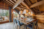 Experience luxury living in this stunning chalet, featuring a spacious dining area perfect for entertaining.