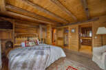 Experience rustic elegance in this stunning bedroom featuring warm wooden accents throughout.