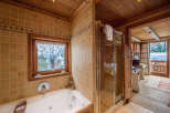 Experience luxury in this stunning bathroom featuring a jacuzzi tub and a separate shower.