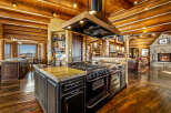 Experience luxury living in this stunning log home, featuring a gourmet kitchen with a professional-grade range and a spacious island.