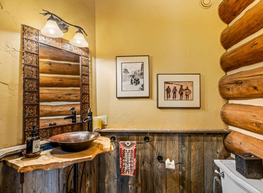 Step into rustic elegance with this stunning bathroom, featuring a unique log cabin aesthetic.