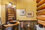 Step into rustic elegance with this stunning bathroom, featuring a unique log cabin aesthetic.