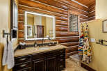 Step into luxury with this stunning bathroom featuring a rustic log cabin aesthetic.