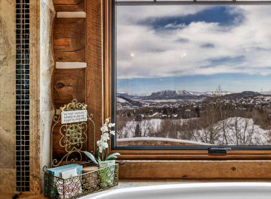 Enjoy breathtaking mountain views from this luxurious bathroom.