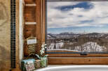 Enjoy breathtaking mountain views from this luxurious bathroom.