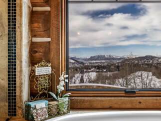Enjoy breathtaking mountain views from this luxurious bathroom.