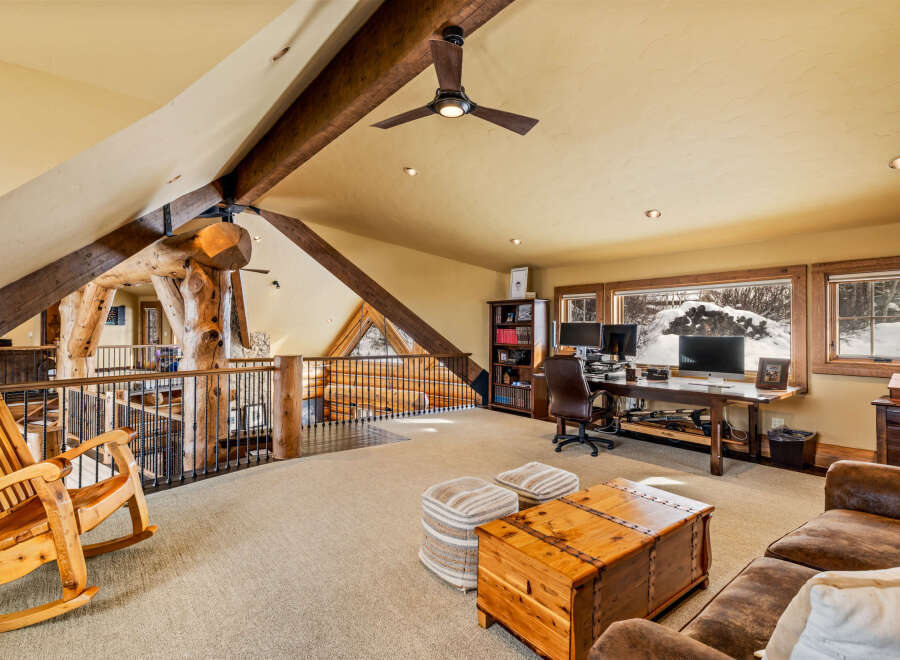 This stunning property boasts a unique loft-style design with exposed wooden beams and a cozy, inviting atmosphere.