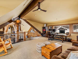 This stunning property boasts a unique loft-style design with exposed wooden beams and a cozy, inviting atmosphere.