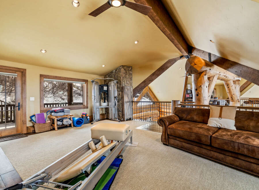 This stunning property boasts a spacious interior with a unique architectural design, featuring exposed wooden beams and a cozy, inviting atmosphere.