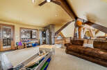 This stunning property boasts a spacious interior with a unique architectural design, featuring exposed wooden beams and a cozy, inviting atmosphere.