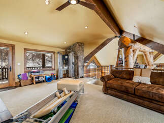This stunning property boasts a spacious interior with a unique architectural design, featuring exposed wooden beams and a cozy, inviting atmosphere.