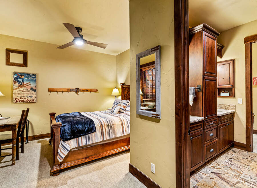 This cozy bedroom features a rustic wooden bed frame, complemented by a warm color palette and inviting decor.