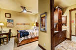 This cozy bedroom features a rustic wooden bed frame, complemented by a warm color palette and inviting decor.