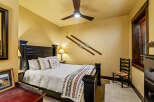 This cozy bedroom features a comfortable bed with plush pillows and a decorative blanket, perfect for a relaxing retreat.