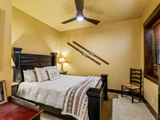 This cozy bedroom features a comfortable bed with plush pillows and a decorative blanket, perfect for a relaxing retreat.