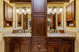 This stunning bathroom boasts a luxurious double vanity with rich, dark wood cabinetry, offering ample storage and a touch of elegance.