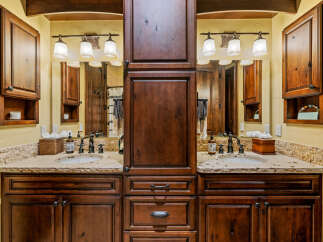 This stunning bathroom boasts a luxurious double vanity with rich, dark wood cabinetry, offering ample storage and a touch of elegance.