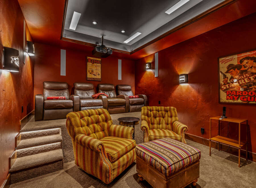 Step into luxury with this stunning home theater! Featuring plush leather recliners, a state-of-the-art projector, and a cozy seating area, this space is perfect for movie nights.
