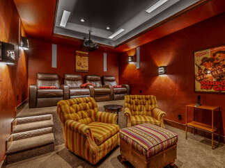 Step into luxury with this stunning home theater! Featuring plush leather recliners, a state-of-the-art projector, and a cozy seating area, this space is perfect for movie nights.