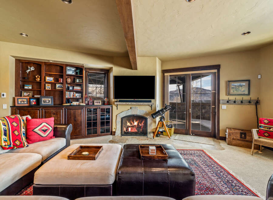 Step into luxury with this stunning living room, featuring a cozy fireplace and a built-in entertainment center.