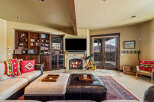 Step into luxury with this stunning living room, featuring a cozy fireplace and a built-in entertainment center.