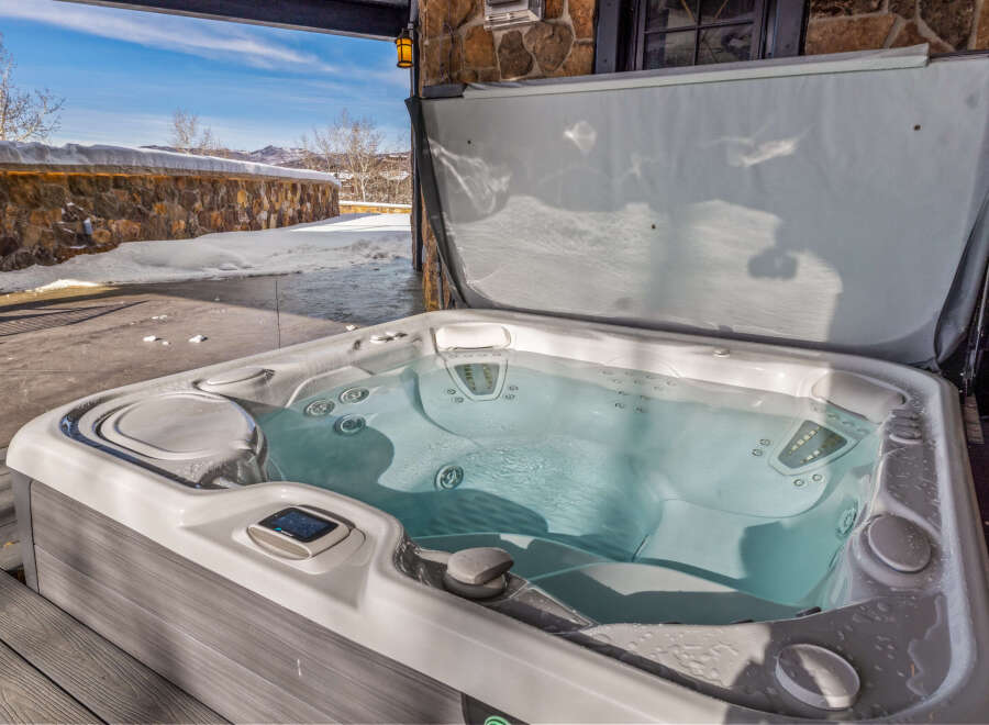 Relax and unwind in this luxurious hot tub, perfect for enjoying the stunning mountain views.
