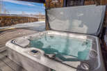 Relax and unwind in this luxurious hot tub, perfect for enjoying the stunning mountain views.