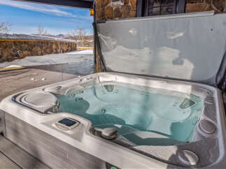 Relax and unwind in this luxurious hot tub, perfect for enjoying the stunning mountain views.