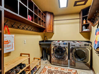 This laundry room boasts a functional design with ample storage and modern appliances.