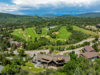 Discover luxury living in this stunning property with breathtaking views of a lush golf course and serene lake.