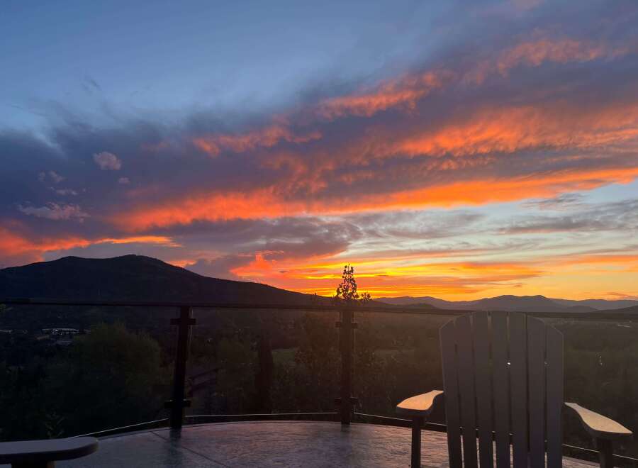 Enjoy breathtaking sunsets from this stunning property! This home boasts a spacious deck with comfortable seating, perfect for taking in the panoramic views.