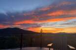 Enjoy breathtaking sunsets from this stunning property! This home boasts a spacious deck with comfortable seating, perfect for taking in the panoramic views.