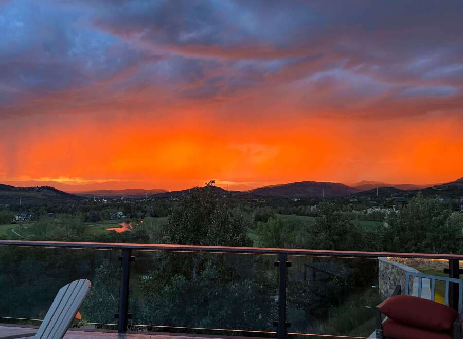 Experience breathtaking sunsets from this stunning property! This home offers panoramic views of the surrounding mountains and lush greenery.