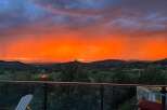 Experience breathtaking sunsets from this stunning property! This home offers panoramic views of the surrounding mountains and lush greenery.