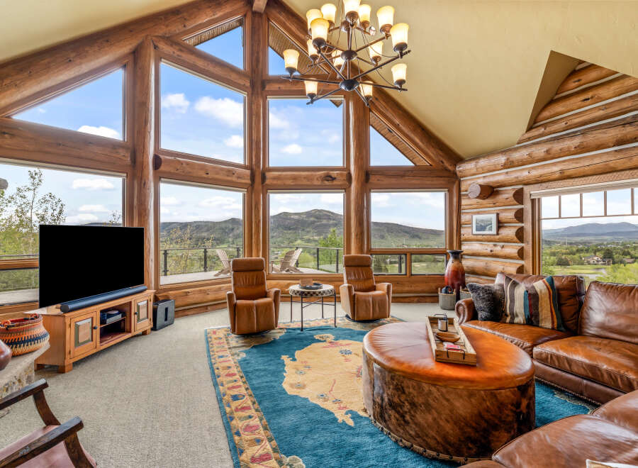 Experience luxury living in this stunning log cabin home, boasting breathtaking mountain views and an abundance of natural light.