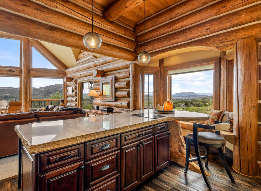 Experience the rustic charm of this stunning log cabin kitchen, perfect for entertaining and everyday living.
