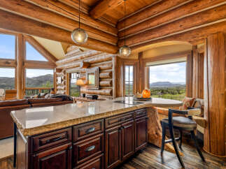 Experience the rustic charm of this stunning log cabin kitchen, perfect for entertaining and everyday living.