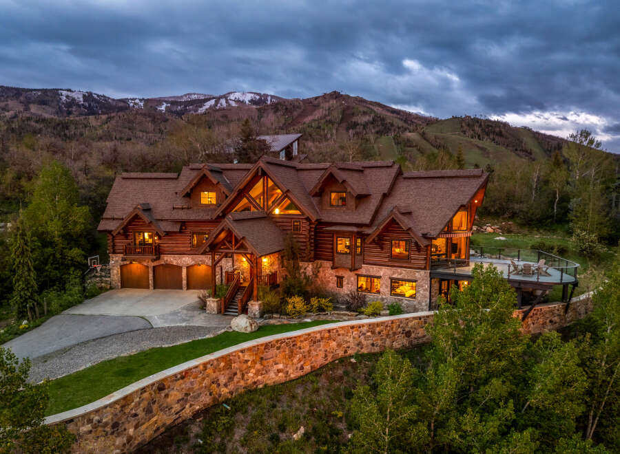 This stunning mountain home offers luxurious living with its rustic charm and breathtaking views.