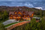 This stunning mountain home offers luxurious living with its rustic charm and breathtaking views.