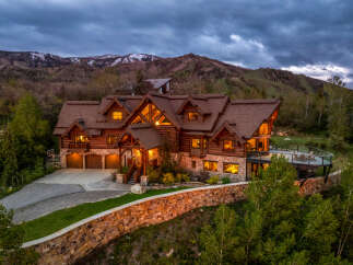 This stunning mountain home offers luxurious living with its rustic charm and breathtaking views.