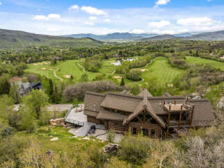 This stunning property boasts a luxurious log cabin design, offering a unique and inviting living experience.