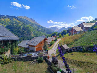 Discover your dream home in this picturesque mountain village! This charming property boasts stunning views of the surrounding peaks and lush greenery.