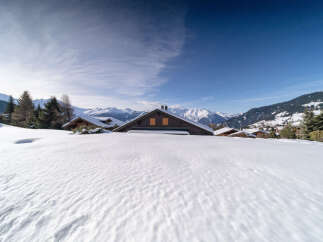 Nestled in a picturesque winter wonderland, this charming property offers a serene escape.