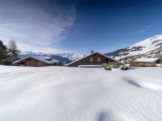 Nestled in a picturesque winter wonderland, this charming property offers a serene escape.