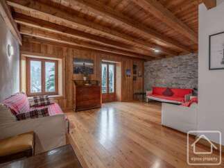 This stunning property boasts a warm and inviting interior, featuring beautiful wooden floors and ceilings that create a cozy atmosphere.