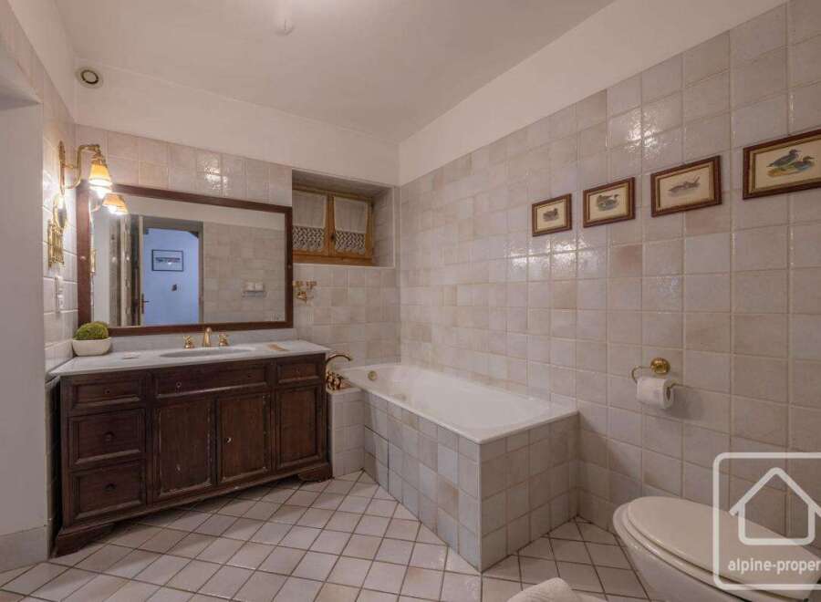 This elegant bathroom features a classic design with a touch of rustic charm.