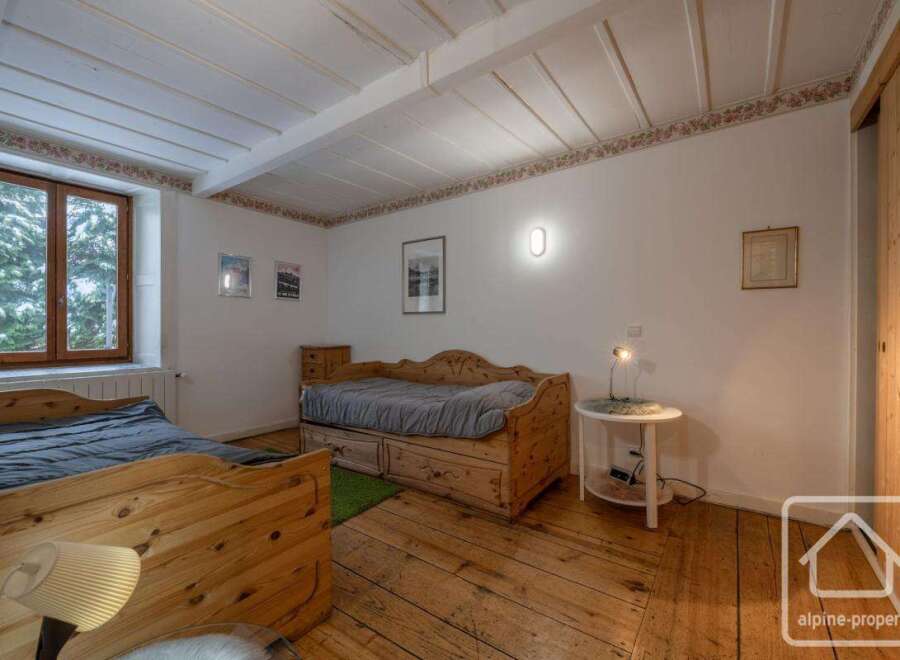 This charming bedroom features rustic wooden furniture and a cozy atmosphere.