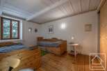 This charming bedroom features rustic wooden furniture and a cozy atmosphere.