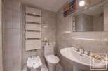 This bathroom features a modern design with a sleek white sink and a stylish towel rack.